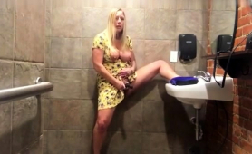 buxom-amateur-milf-pleases-her-fiery-cunt-in-a-public-toilet